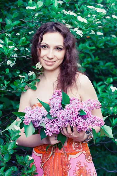Woman with lilac flowers — Stock Photo, Image