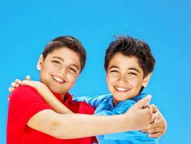 Happy cute boys over blue sky clipart