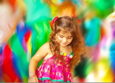 Adorable small girl dancing over blur colors background clipart