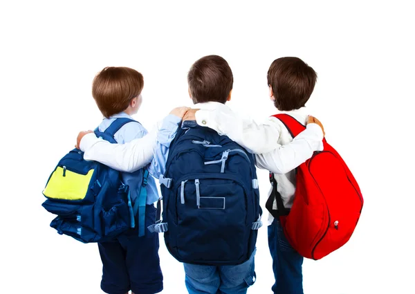 Drie schooljongens geïsoleerd op witte achtergrond — Stockfoto