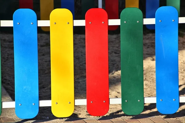 stock image Wooden fence painted in bright colors