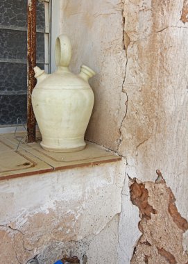 Old jug botijo in window of old house typical Spanish clipart
