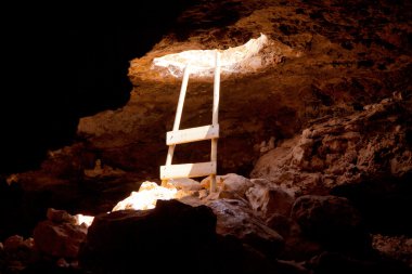 Barbaria cape cave hole with rustic ladder on wood clipart