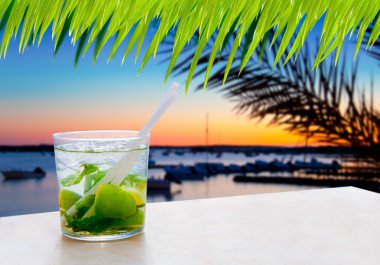 Cocktail Mojito in Balearic island sunset clipart