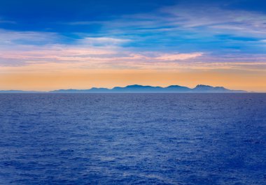 Ibiza sunset in Balearic islands view from sea clipart