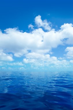 Blue calm sea water in with clouds mirror surface clipart