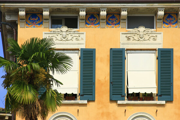 Impressions from the Lake Garda, Italy - decorative facade and palm