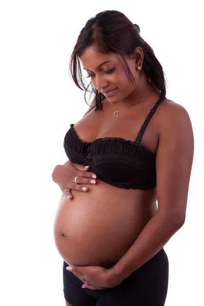 Young beautiful pregnant indian woman touching her tummy Stock Image