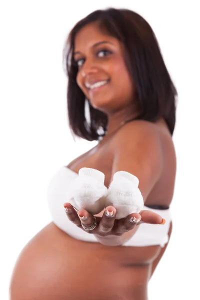 Young pregnant indian woman holding baby shoes — Stock Photo, Image