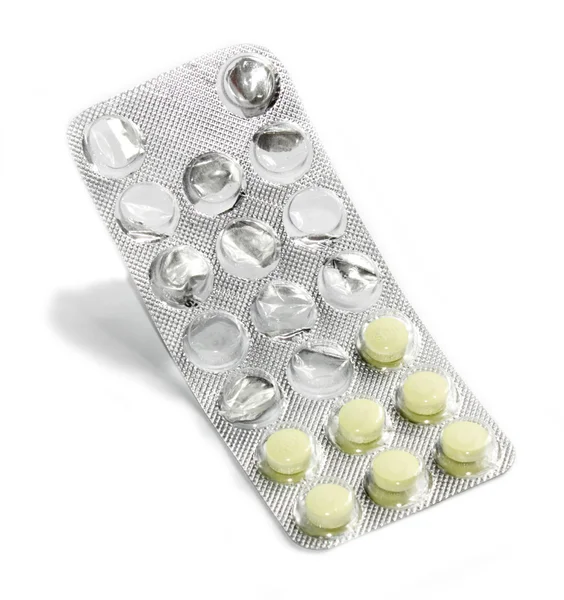 Старі таблетки упаковані з тіні на білому тлі — стокове фото
