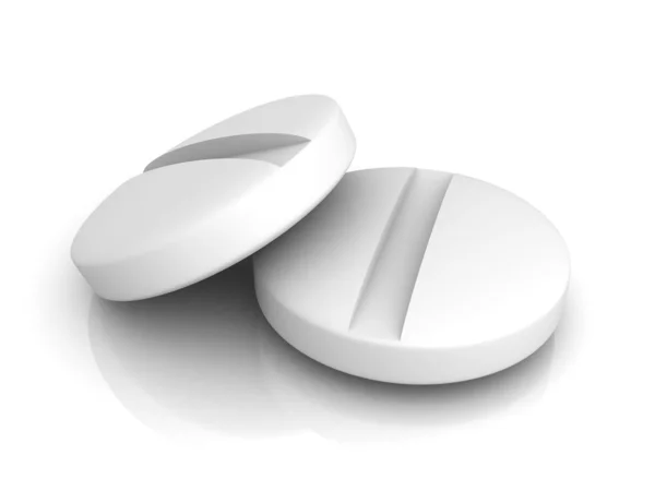 Дві білі медичні таблетки на білому тлі — стокове фото