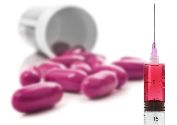 Růžové pilulky pilulku láhev na bílém pozadí — Stock fotografie
