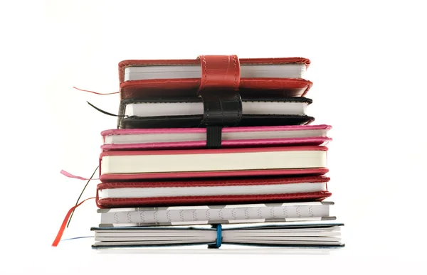 Close up of stacked up books on a white background — Stock Photo, Image