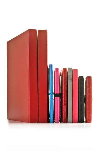 Close up of stacked up books on a white background — Stock Photo, Image