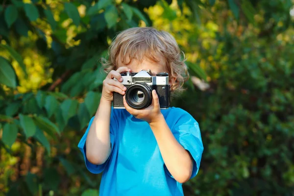 Young beautiful photographer with a camera shoots you - Stock Image ...