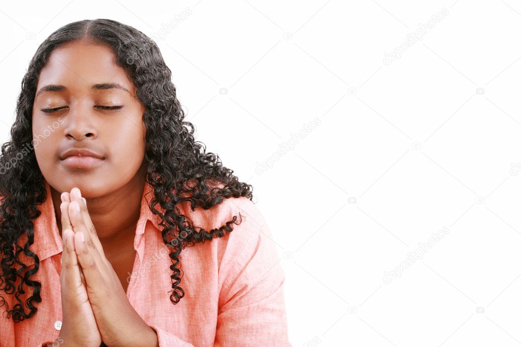 Woman praying isolated on a white background.