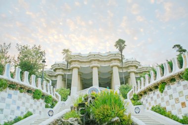 Pavilion decorated with mosaic in Park Guell starting the sunset clipart