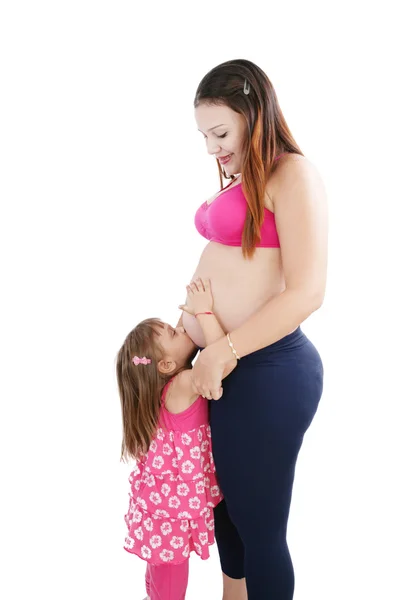 Nice Caucasian woman pregnant with her daughter on the backgroun — Stock Photo, Image