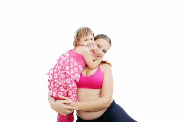 Beautiful pregnant woman with her daughter. Isolated on white ba — Stock Photo, Image