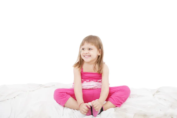Portrait of a cute little girl sitting on floor, isolated over w — Stock Photo, Image