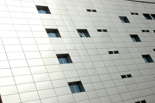Square pattern on the building with some windows — Stock Photo, Image