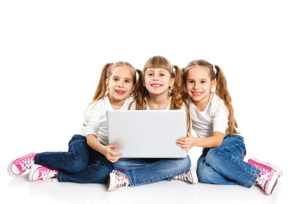 Drei attraktive Mädchen mit einem Laptop — Stockfoto