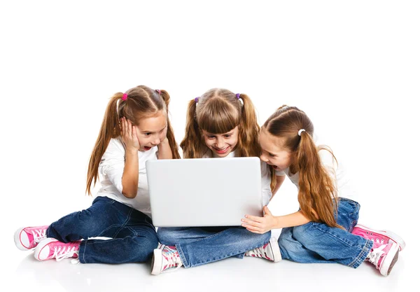 Three attractive girl using a laptop — Stock Photo, Image