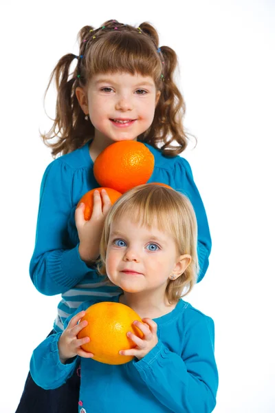 Happy girls with oranges — Stock Photo, Image