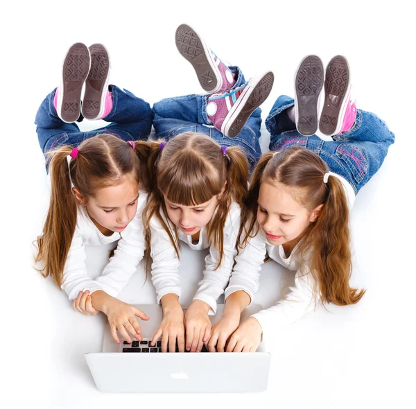 Drei attraktive Mädchen mit einem Laptop — Stockfoto