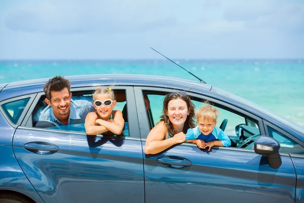 Family of four driving in a car — Stock Photo, Image