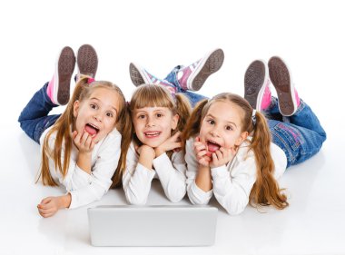 Three attractive girl using a laptop clipart