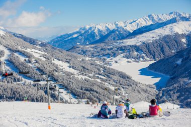 Snowboarders on skiing resort in Austria clipart