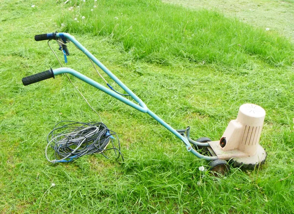 stock image Aging lawn mower on green herb