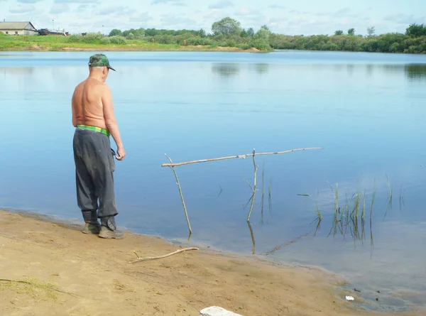 Fisherman on river goes fishing