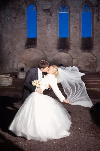 Groom and the bride in stone court yard of castle — Stock Photo, Image