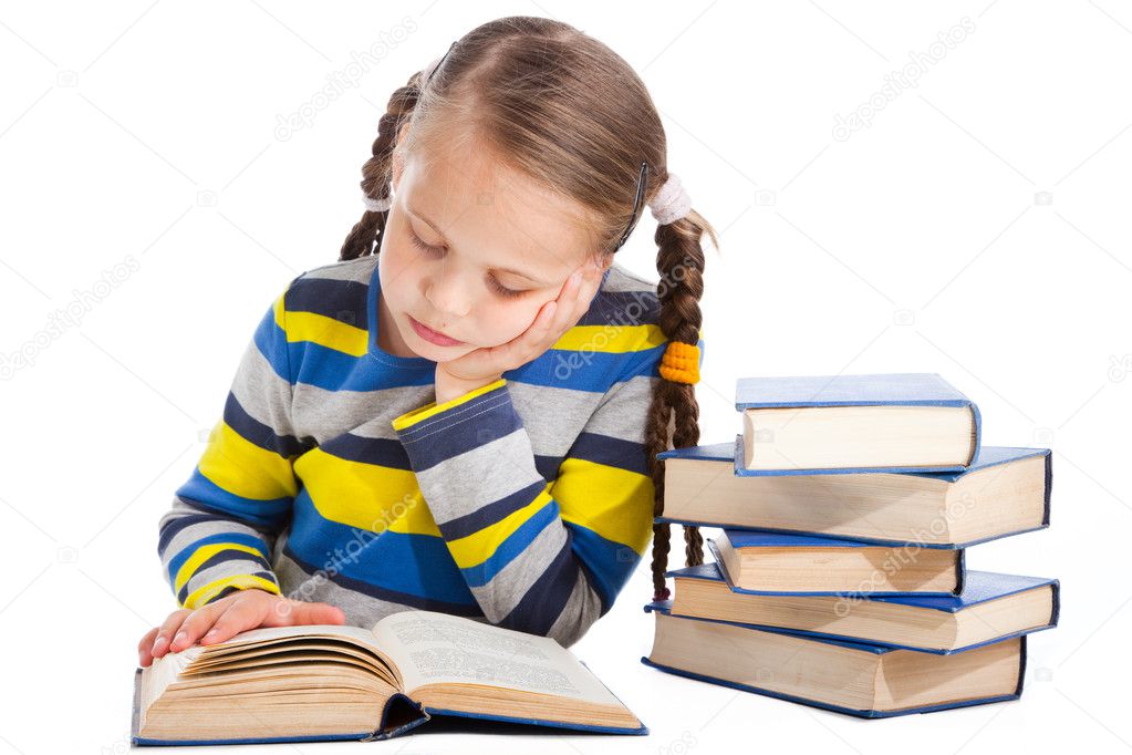 Schoolgirl attentively reading the book on isolated white