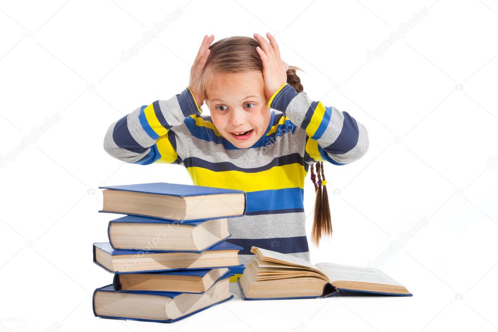 Schoolgirl with horror looking at pile of books on isolated white