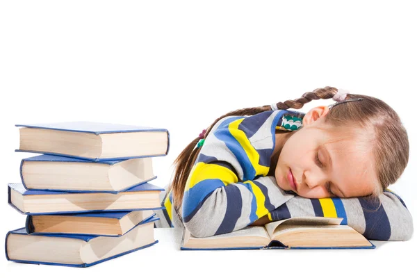 Schulmädchen schläft über dem Buch auf isoliertem Weiß — Stockfoto