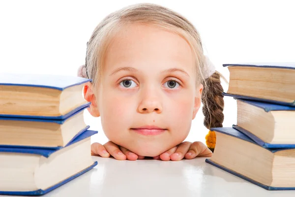 Girl between the books on isolated white — Stock Photo, Image