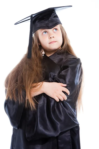 Jolie fille en casquette académique noire et robe — Photo