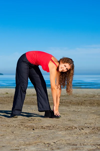 Girl doing morning exercises at the beach — Stock Photo, Image