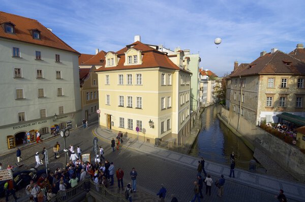 Prague, Czech Republic - October 11, 2008: Tourists walking near the Charles Bridge, one of the most visited places in the city.