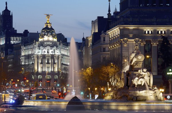 Madrid, Spain - March 22, 2012: heavy traffic in the historic center of Madrid, highlights the Metropolis building and the Cibeles fountain, two of the most visited monuments in the city.