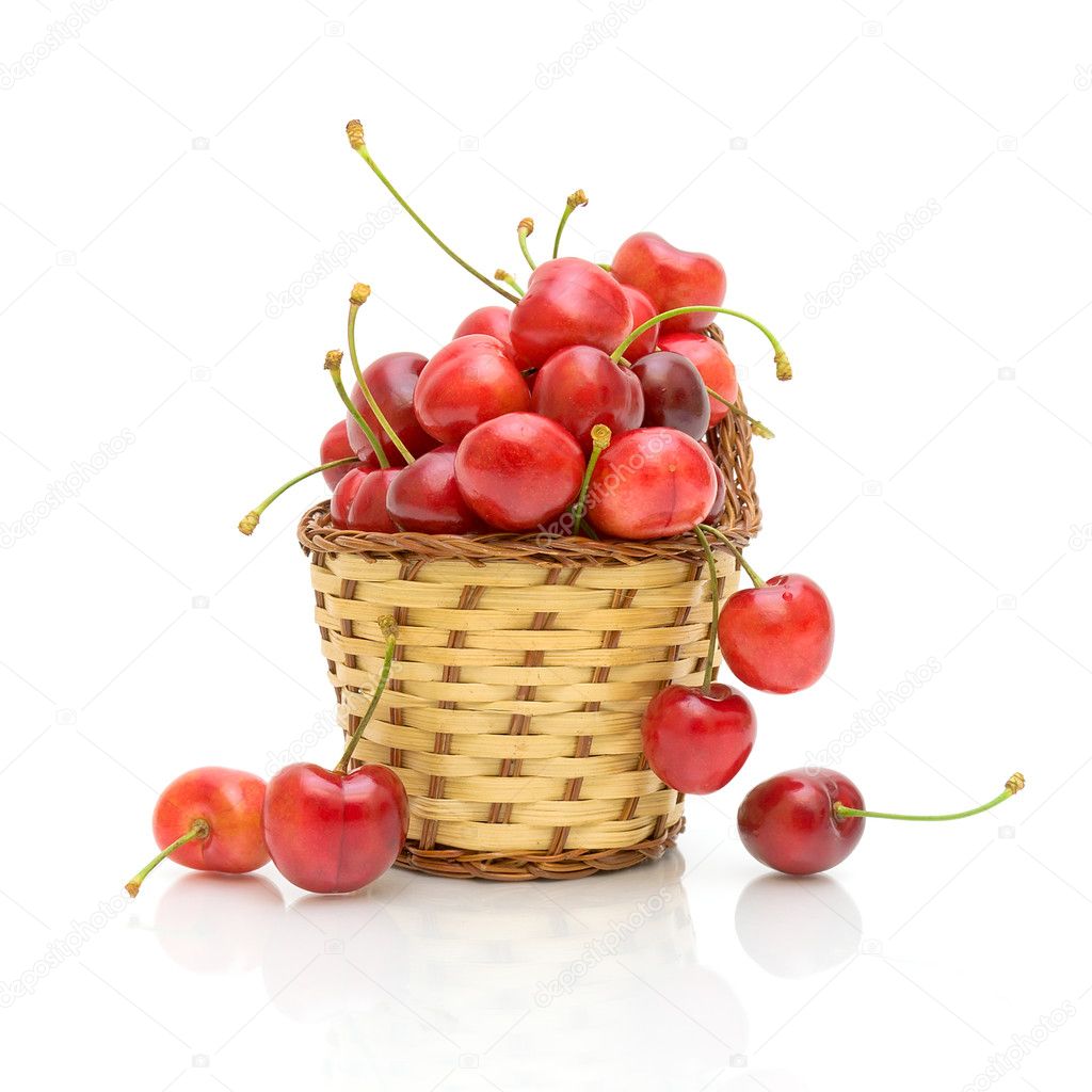 Ripe cherries in a basket on a white background