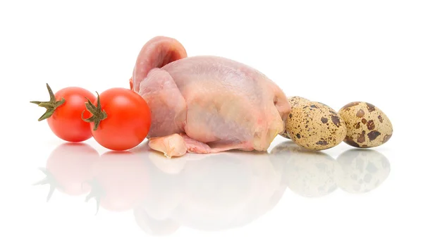 Raw quail carcass, tomatoes and eggs on a white background — Stock Photo, Image