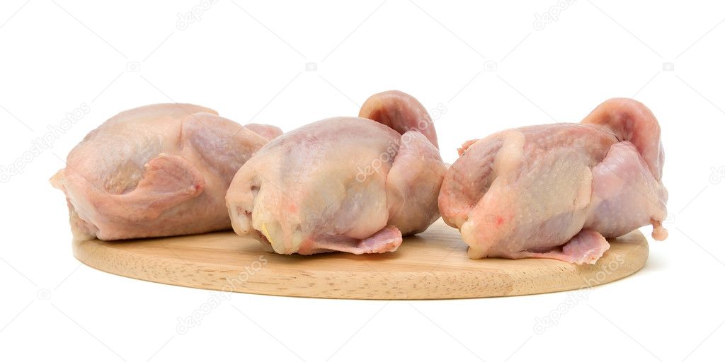 Quail carcasses on a cutting board on a white background