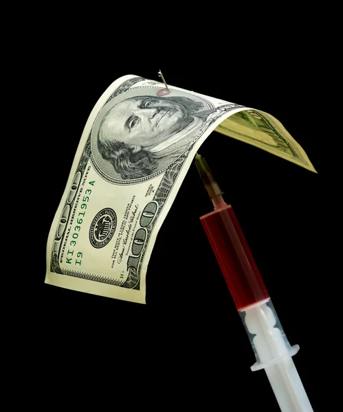 One hundred dollars and syringe isolated on a black background — Stock Photo, Image