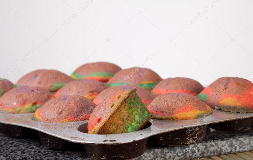 Studio shot of home made rainbow cupcakes