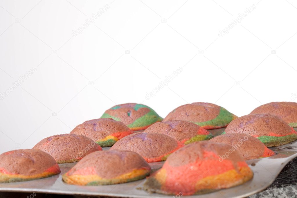 Studio shot of home made rainbow cupcakes