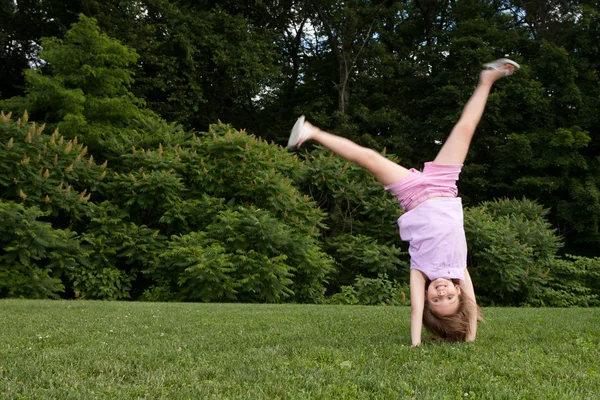 Little girl doing a cartwheel — Stock Photo, Image